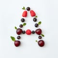 Berries pattern of letter A english alphabet from natural ripe berries - black currant, cherries, raspberry, mint leaf Royalty Free Stock Photo