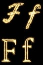 Letter F. Alphabet made by sparkler. Isolated on a black background. Royalty Free Stock Photo