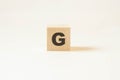 Letter G on white background printed on wood. Concept of composing words Royalty Free Stock Photo