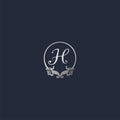 Letter H Decorative Crown Ring Alphabet Logo isolated on Navy Blue Background. Luxury Silver Initial Abjad Logo Design Template.