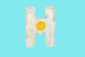 The letter H from a fried egg Royalty Free Stock Photo