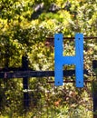 Letter H Hangs on Rustic Fence