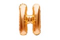 Letter H made of golden inflatable helium balloon isolated on white. Gold foil balloon font part of full alphabet set of upper Royalty Free Stock Photo