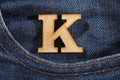 Letter K of the alphabet - blue jeans texture background. Top view Royalty Free Stock Photo