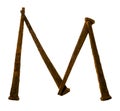 Alphabet Letter M made from Antique Rusty Nails Isolated on White