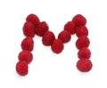 letter M made from raspberries. isolated on white background for birthday party