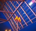Letter M - symbol of underground transport-metro on background against a transparent canopy