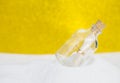 Letter in message bottle on white sand Royalty Free Stock Photo