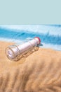 Letter message in a glass transparent bottle on the sandy beach with palm leaf shadow, concept for communication. Abstract modern Royalty Free Stock Photo