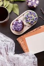 Letter mockup, crafting envelope. Aesthetics purple floral cupcakes and cup of coffee. No sugar sweet dessert among