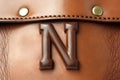 letter n, from leather, on white background