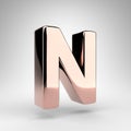 Letter N uppercase on white background. Rose gold 3D letter with gloss chrome surface