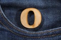 Letter O of the alphabet - blue jeans texture background. Top view Royalty Free Stock Photo