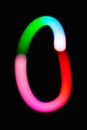 Letter O. Glowing letters on dark background. Abstract light painting at night. Creative artistic colorful bokeh. New Year. Royalty Free Stock Photo