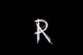 Letter R written with light paint photography technique on black background.