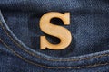Letter S of the alphabet - blue jeans texture background. Top view Royalty Free Stock Photo