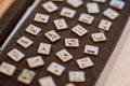 Letter stamp made of metal for leather processing placed on a felt plate, letter x is in focus