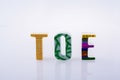 Letter standees spelling the word TOE on a white background