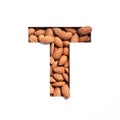 Letter T of English alphabet made of natural nuts and paper cut isolated on white. Typeface from almonds