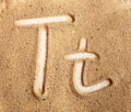 Letter T. English Handwritten Alphabet In The Sand Royalty Free Stock Photo