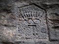 Letter T and the kings crown.  Rock relief and engraving in chalk sandstone Royalty Free Stock Photo