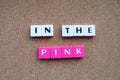 Letter tiles spelling in the pink in good health Royalty Free Stock Photo