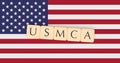 Letter Tiles USMCA On US Flag, 3d illustration