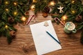Letter to Santa. Christmas Wish List. Empty White Paper over Xmas Decorated Brown Wooden Table with Cup of Hot Drink. New Year