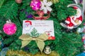 A letter to Santa Claus at the North Pole in Lapland lies with toys and ornaments and on the Christmas tree. Royalty Free Stock Photo