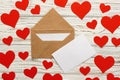 Letter to Valentine Day. Love letter envelope with red hearts on wooden background Royalty Free Stock Photo