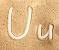 Letter U. English Handwritten Alphabet In The Sand Royalty Free Stock Photo