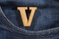 Letter V of the alphabet - blue jeans texture background. Top view Royalty Free Stock Photo