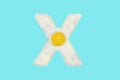 The letter X from a fried egg Royalty Free Stock Photo