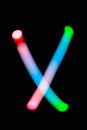 Letter X. Glowing letters on dark background. Abstract light painting at night. Creative artistic colorful bokeh. New Year.