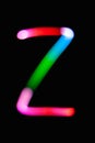 Letter Z. Glowing letters on dark background. Abstract light painting at night. Creative artistic colorful bokeh. New Year.