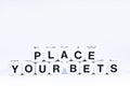 Lettered dice spelling out the phrase place your bets