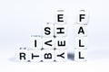 Lettered dice spelling out the words rise and fall Royalty Free Stock Photo