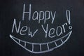 Lettering on chalkboard Happy New Year and drawn smile