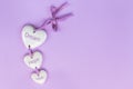 Lettering DREAM, HOPE, WISH on ceramic hearts on a lavender background. Concept for motivational postcard, Royalty Free Stock Photo