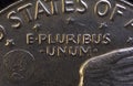 Lettering E Pluribus Unum, one out of many, on the reverse of the one dollar USA coin issued in 1978, isolated on the black