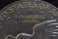 Lettering E Pluribus Unum, one out of many, on the reverse of the one dollar USA coin issued in 1978, isolated on the