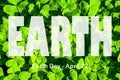 Lettering Earth Day April 22 on the background of clover. Earth day concept, protection of the planet from pollution, improvement