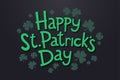 Lettering Happy Saint Patrick`s day with clover leaves. Isolated objects on dark background.