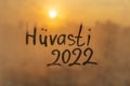 lettering Huvasti in Estonian is goodbye in english and numbers 2022 paint with finger of water on splashed by rain