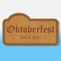 Lettering Oktoberfest on a wooden nameplate. Background for beer festival Oktoberfest in cartoon style. Vector Royalty Free Stock Photo