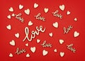 Letterings ÃÂ«loveÃÂ» and wooden hearts on red paper