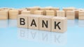 letters bank made with wood building blocks. blue background. business concept Royalty Free Stock Photo