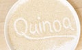 Letters drawn by hand to the quinoa seeds on a white plate