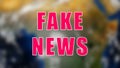 Letters of Fake news text on background with rotating earth, 3d render background, computer generating for news Royalty Free Stock Photo