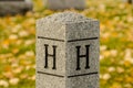 Letters H carved on a stone post